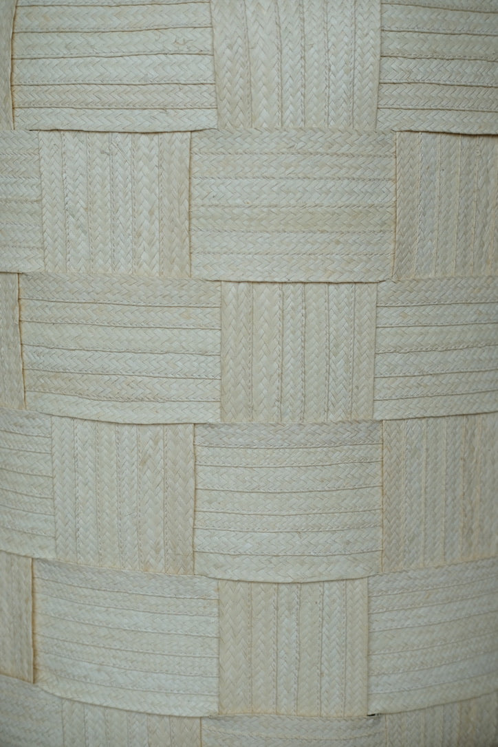 Tall handwoven caña flecha ottoman with interwoven construction, showcasing natural fiber texture and sculptural form crafted by Colombian artisans.