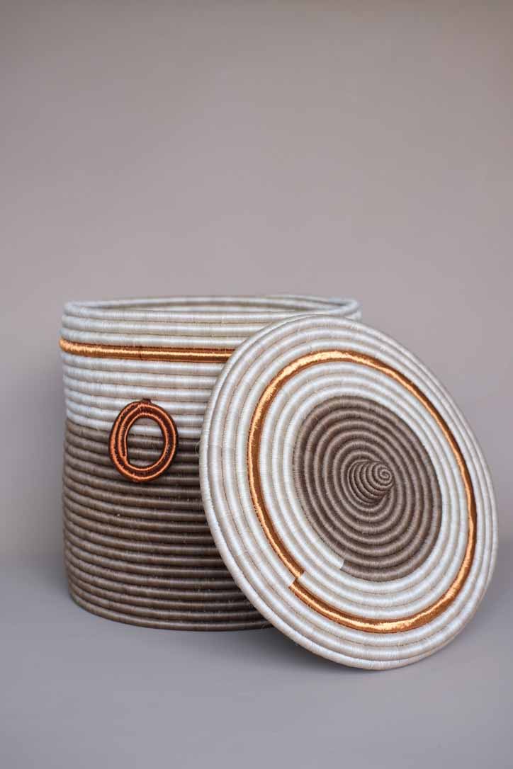 Handwoven brown fique basket with copper detailing, showcasing natural fiber texture and artisanal Colombian craftsmanship.